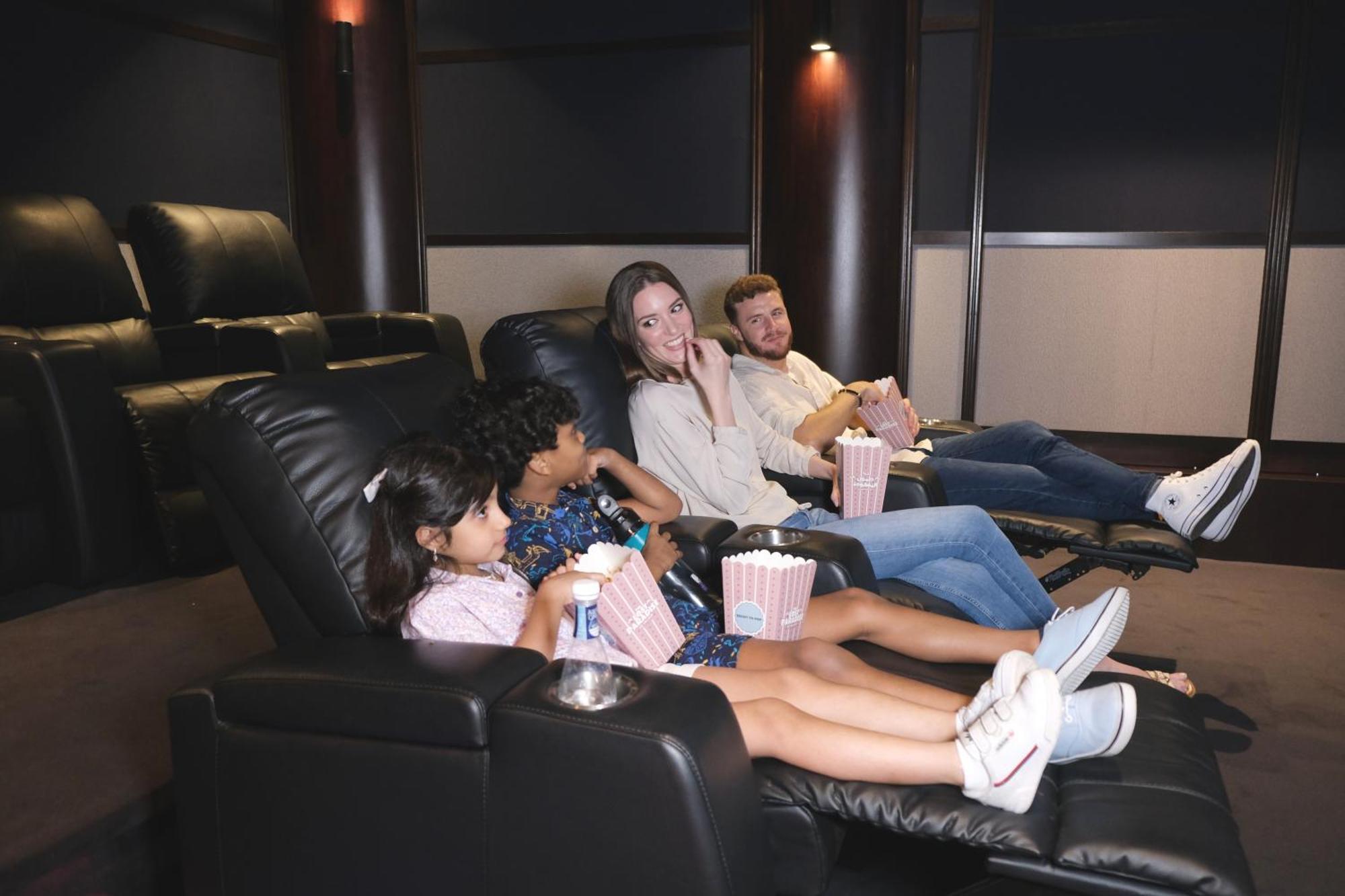 Charthouse Bahrain Hotel Manáma Kültér fotó A family watching a movie in a home theater